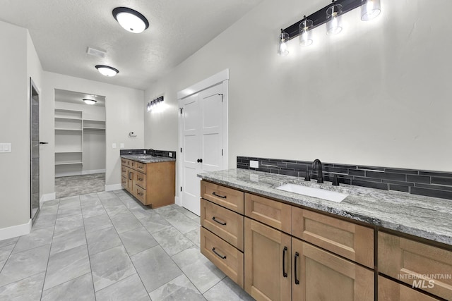 bathroom featuring a textured ceiling and vanity