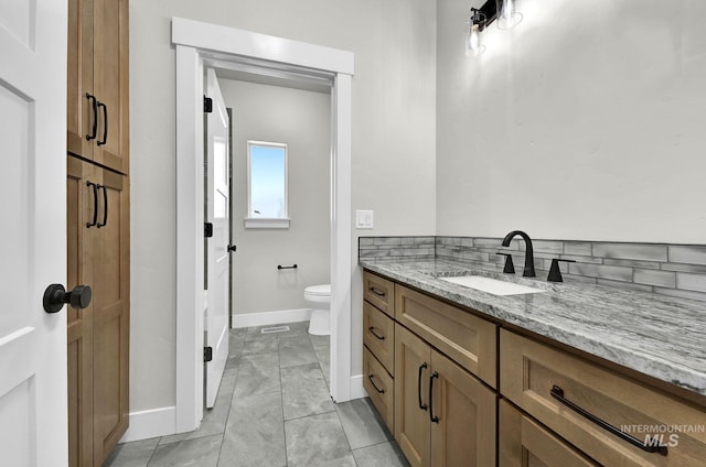 bathroom with vanity, tile patterned flooring, and toilet