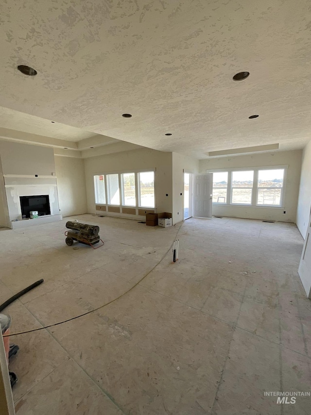 unfurnished living room featuring plenty of natural light