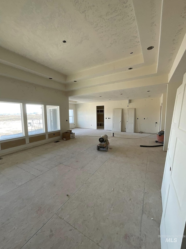 empty room with a water view and a raised ceiling