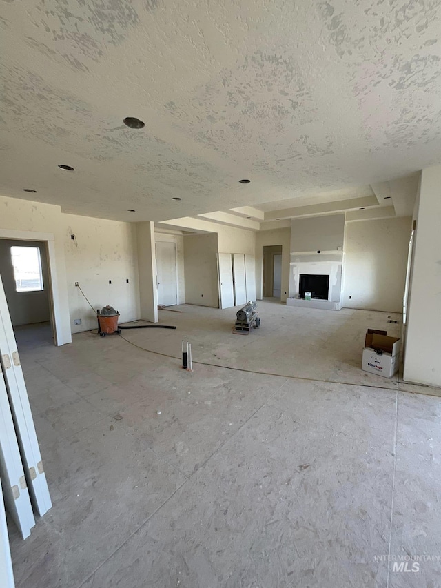 unfurnished living room featuring a textured ceiling