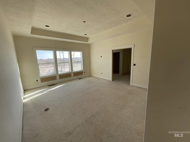 spare room featuring a raised ceiling