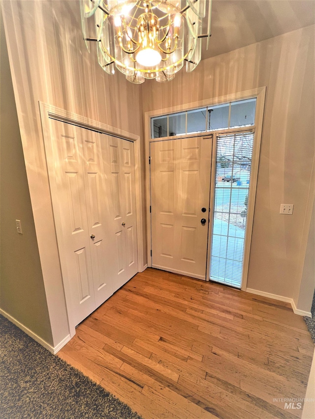 entryway with hardwood / wood-style flooring and an inviting chandelier