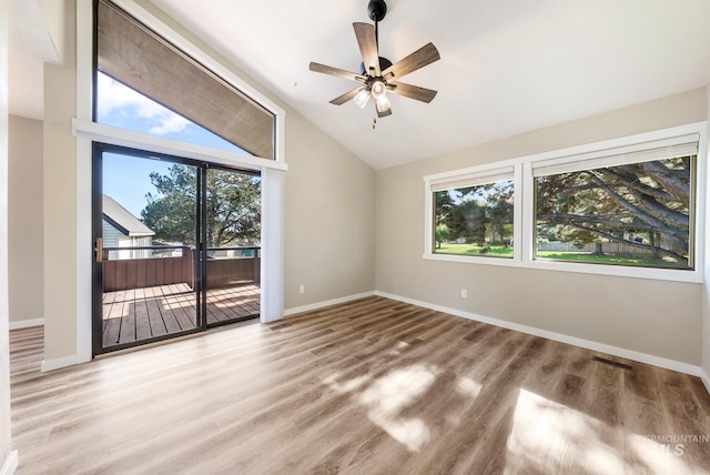 spare room featuring hardwood / wood-style floors, high vaulted ceiling, and ceiling fan