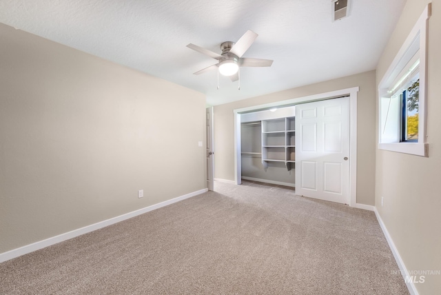 unfurnished bedroom with a closet, carpet, and ceiling fan