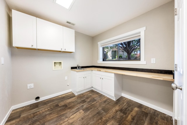 laundry area with hookup for a washing machine, hookup for an electric dryer, sink, dark hardwood / wood-style flooring, and cabinets