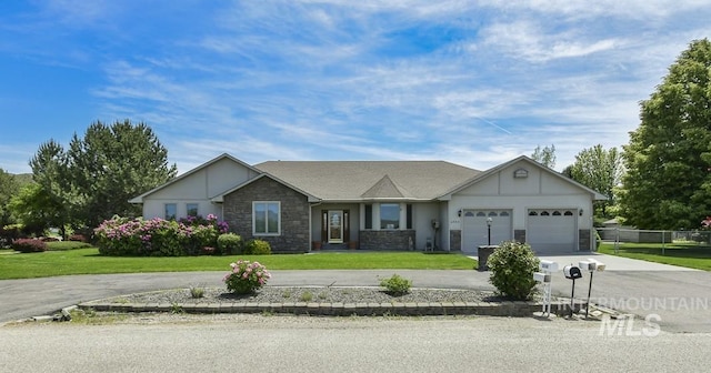 2555 E Quail Run Rd, Emmett, ID 83617 - ranch-style house featuring driveway, stone siding, a front lawn, and an attached garage