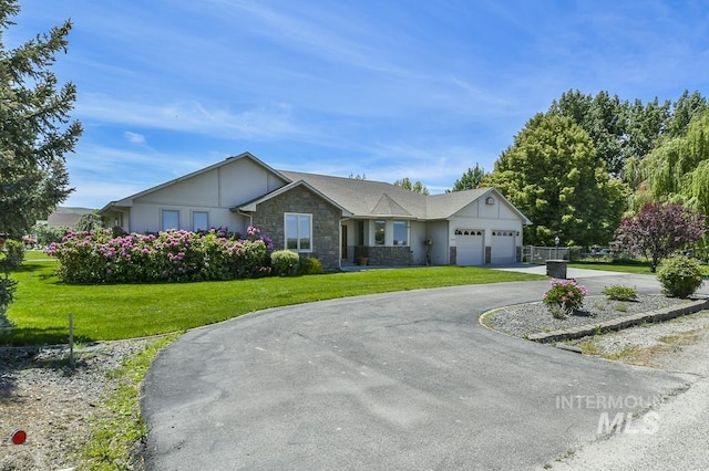2555 E Quail Run Rd, Emmett, ID 83617 - view of front of property with stone siding, asphalt driveway, an attached garage, and a front yard