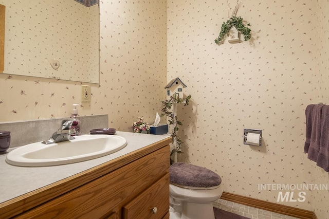 2555 E Quail Run Rd, Emmett, ID 83617 - bathroom with vanity, toilet, and wallpapered walls