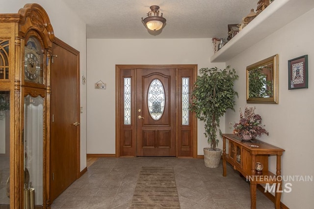 2555 E Quail Run Rd, Emmett, ID 83617 - tiled entryway with a textured ceiling and baseboards