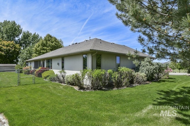 2555 E Quail Run Rd, Emmett, ID 83617 - view of side of home with stucco siding, a gate, and a shingled roof