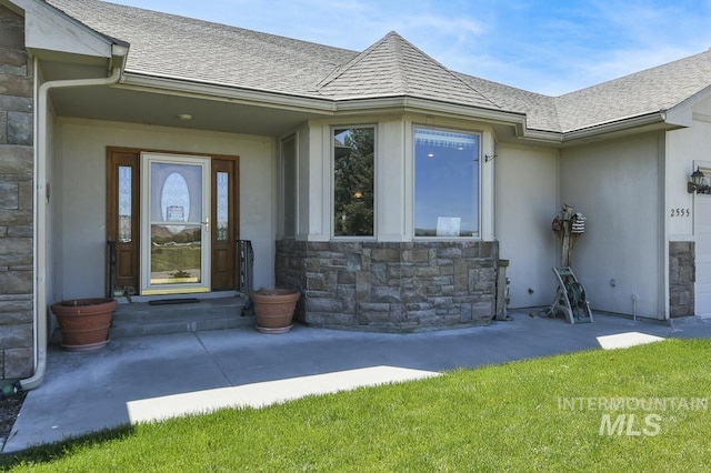 2555 E Quail Run Rd, Emmett, ID 83617 - doorway to property with stone siding, a shingled roof, and stucco siding