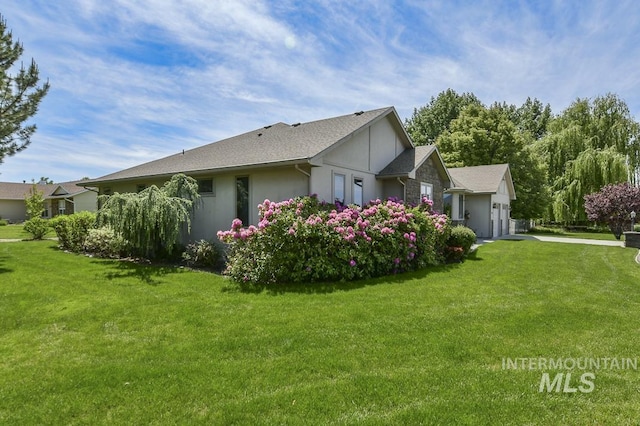 2555 E Quail Run Rd, Emmett, ID 83617 - view of property exterior featuring a lawn and stucco siding