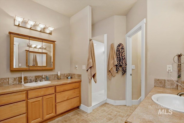 bathroom with baseboards, two vanities, and a sink