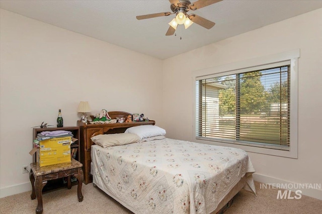 bedroom featuring light carpet, ceiling fan, and baseboards