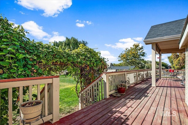 wooden terrace with a yard