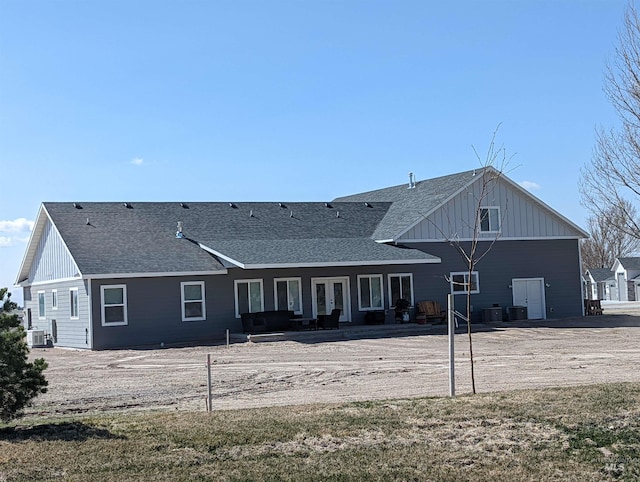 rear view of property with central AC