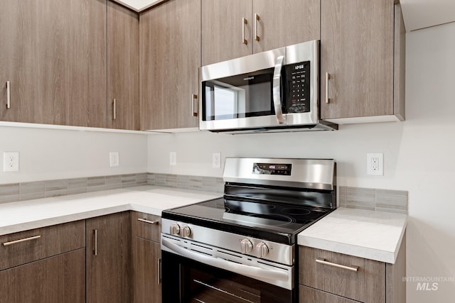 kitchen with modern cabinets, stainless steel appliances, and light countertops