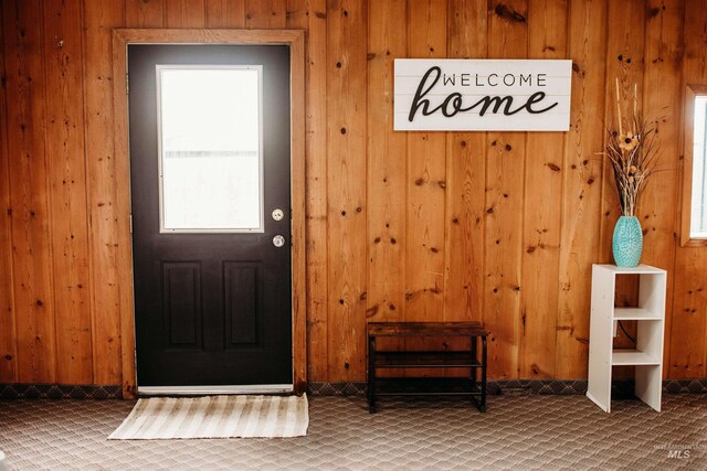 421 Hill St, Grangeville, ID 83530 - doorway to outside featuring carpet flooring and wooden walls