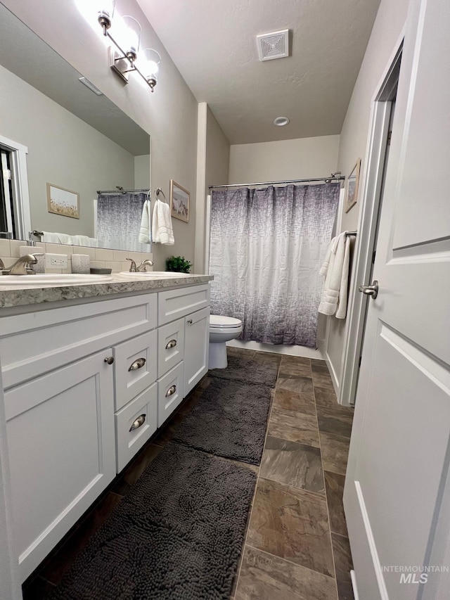 720 Shadowleaf Ave, Twin Falls, ID 83301 - bathroom with toilet, vanity, and a shower with shower curtain