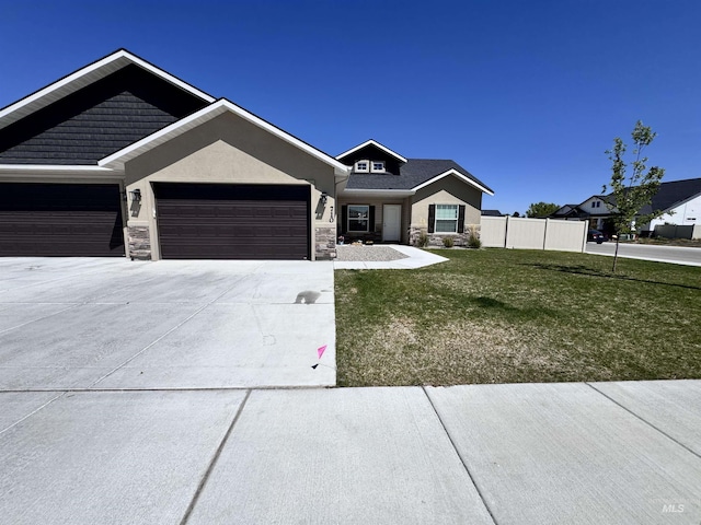 720 Shadowleaf Ave, Twin Falls, ID 83301 - view of front of home with stone siding, driveway, an attached garage, and stucco siding