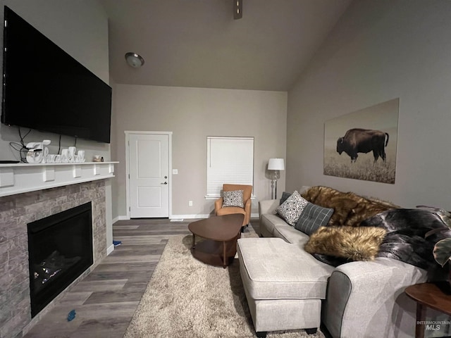 720 Shadowleaf Ave, Twin Falls, ID 83301 - living room featuring dark wood-style floors, baseboards, a fireplace, and high vaulted ceiling