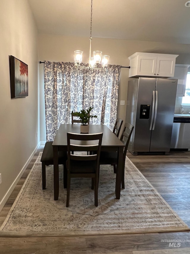 720 Shadowleaf Ave, Twin Falls, ID 83301 - dining space featuring a chandelier, dark wood-style floors, and baseboards