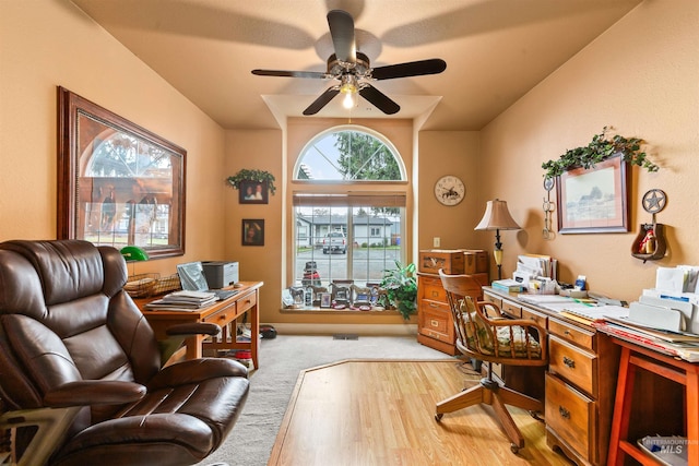 carpeted office featuring ceiling fan