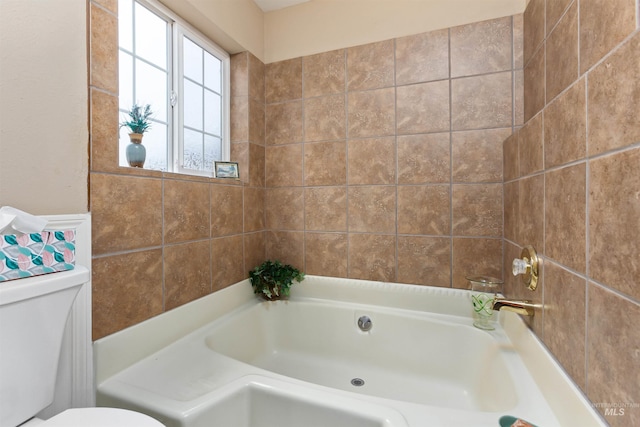 bathroom featuring a bath and toilet