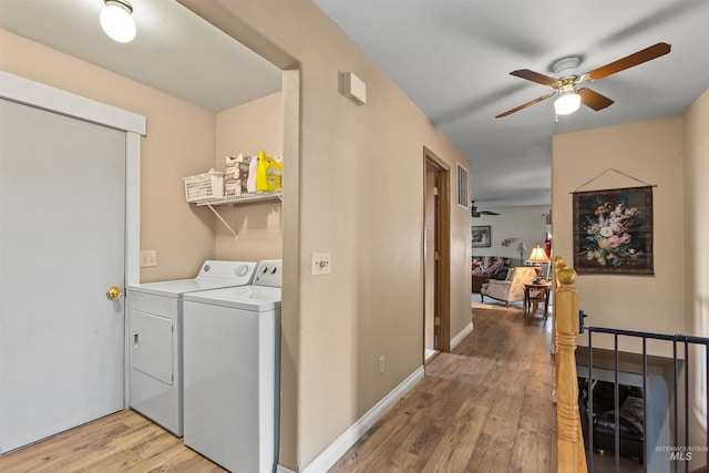 laundry room with ceiling fan, wood-type flooring, and washing machine and clothes dryer