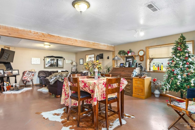 dining room with concrete flooring and a textured ceiling