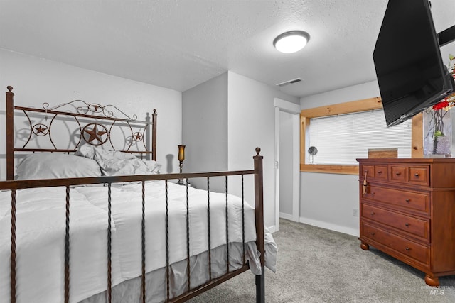 carpeted bedroom featuring a textured ceiling