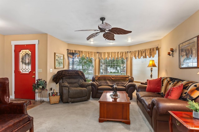 carpeted living room with ceiling fan