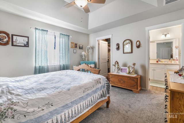 bedroom featuring ceiling fan, ensuite bathroom, carpet flooring, a spacious closet, and a closet