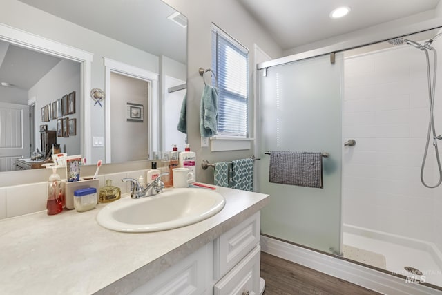 bathroom featuring vanity, wood-type flooring, and an enclosed shower