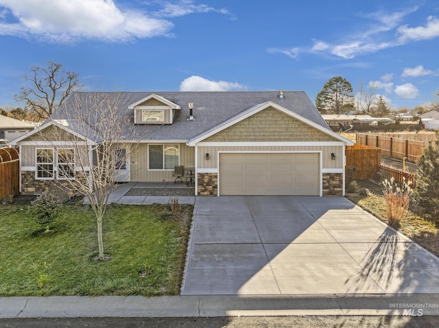 view of front of property with a garage and a front yard
