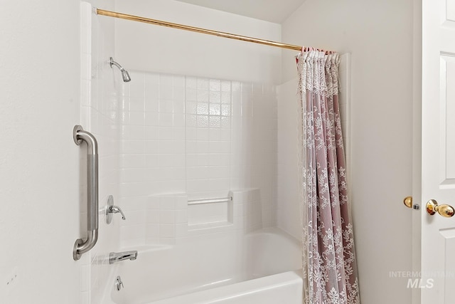 bathroom featuring shower / bath combo with shower curtain