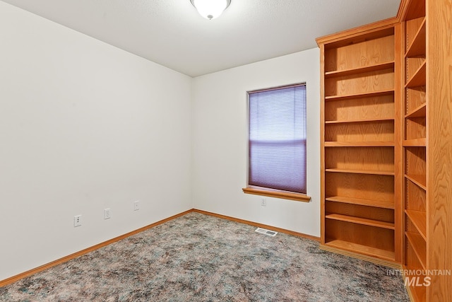 empty room with carpet flooring