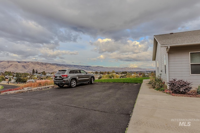 view of car parking with a mountain view