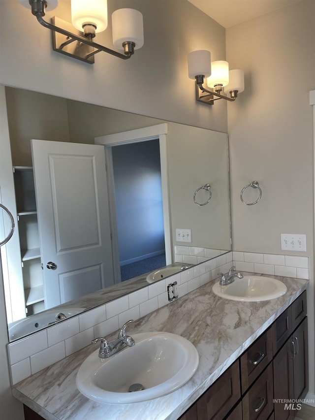 full bathroom featuring double vanity and a sink