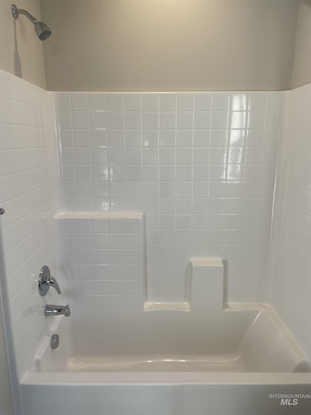 bathroom with bathing tub / shower combination