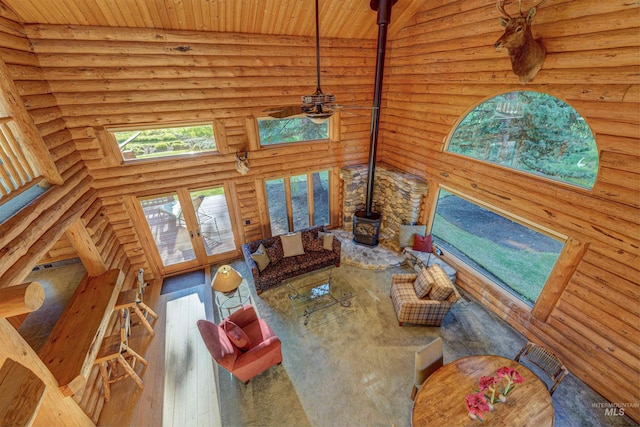 1301 Glen Aspen Dr, Bellevue, ID 83313 - living area featuring a wood stove, wood-type flooring, log walls, french doors, and wood ceiling