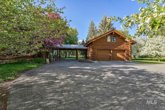 1301 Glen Aspen Dr, Bellevue, ID 83313 - view of home's exterior featuring log exterior, a carport, and a garage