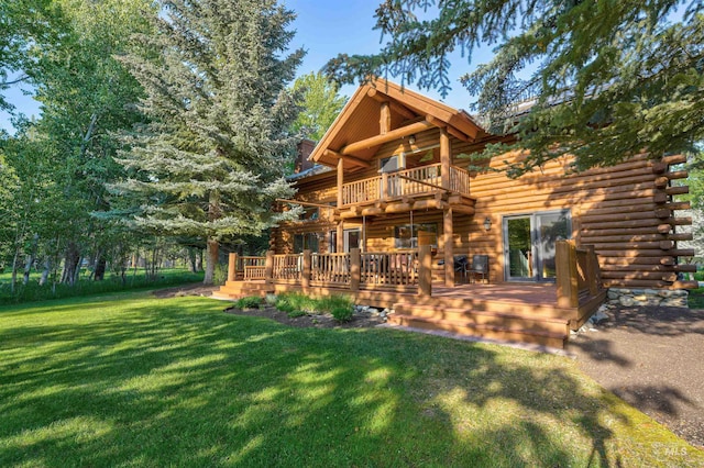 1301 Glen Aspen Dr, Bellevue, ID 83313 - back of property featuring log siding, a lawn, a wooden deck, and a balcony