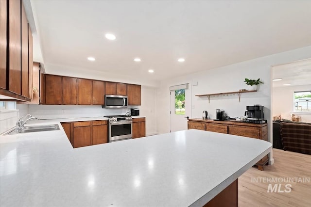 5009 Airport Rd, Nampa, ID 83687 - kitchen with stainless steel appliances, a sink, a peninsula, healthy amount of natural light, and recessed lighting