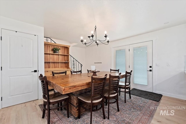 5009 Airport Rd, Nampa, ID 83687 - dining room with light wood-type flooring, a chandelier, stairway, and baseboards