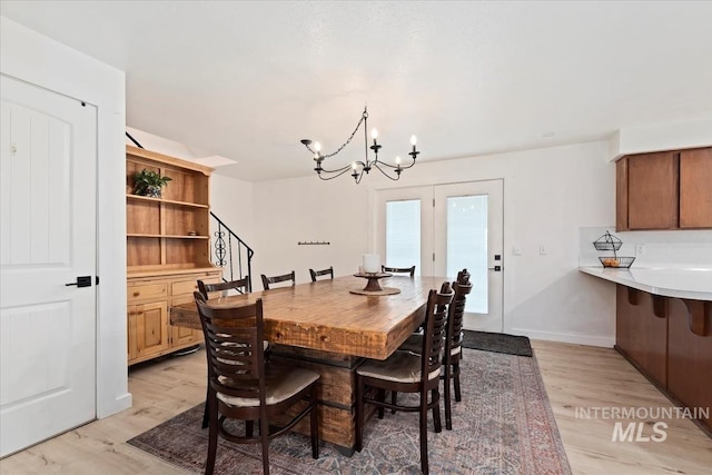 5009 Airport Rd, Nampa, ID 83687 - dining room with light wood-style floors, a chandelier, stairway, and baseboards