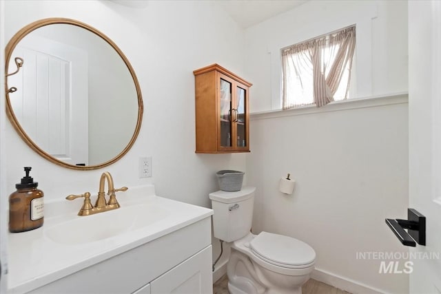 5009 Airport Rd, Nampa, ID 83687 - bathroom featuring toilet, vanity, and baseboards