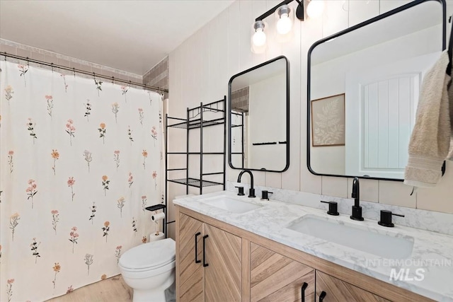 5009 Airport Rd, Nampa, ID 83687 - bathroom featuring double vanity, toilet, a shower with curtain, and wood finished floors