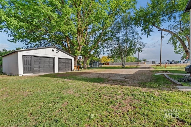 5009 Airport Rd, Nampa, ID 83687 - view of grassy yard featuring an outdoor structure and a garage